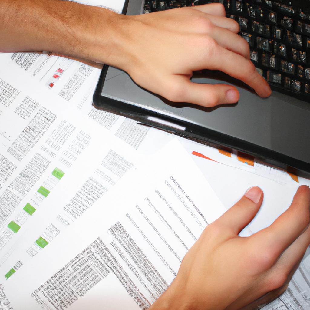 Person analyzing financial documents, typing